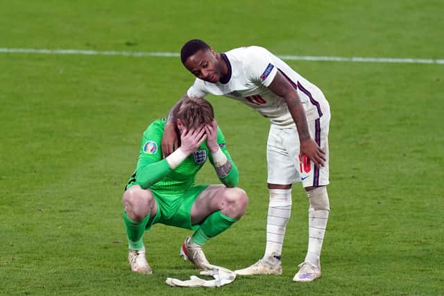 Pickford had to be consoled by Raheem Sterling after the penalty shootout defeat. Photo: Mike Egerton/PA.