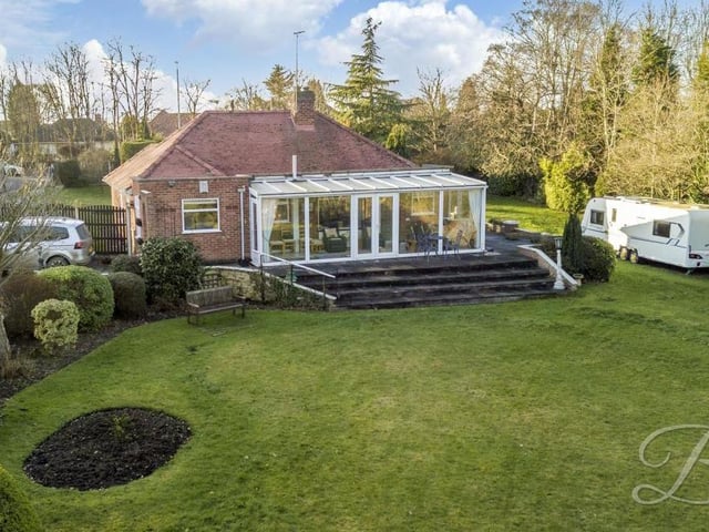 It's time to concentrate on the eyecatching exterior of the property now. This photo shows an aerial view from the rear and the conservatory with its quaint steps leading into the garden.