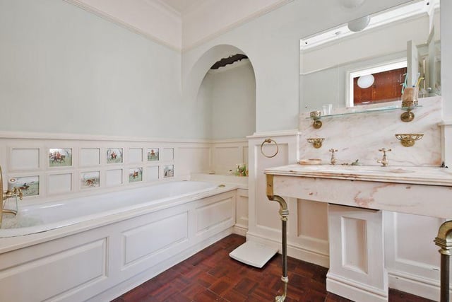 The en-suite bathroom has a jacuzzi bath with shower attachment. There is also a large and ornate marble basin.