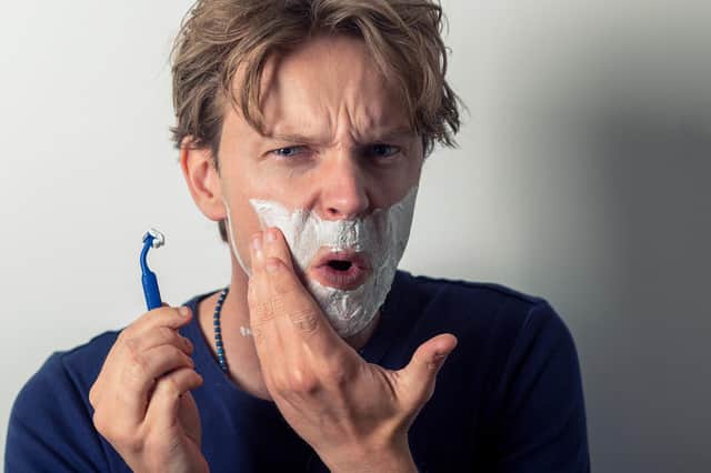 A cut above. An idiot slicing his face with a razor (picture posed by model).