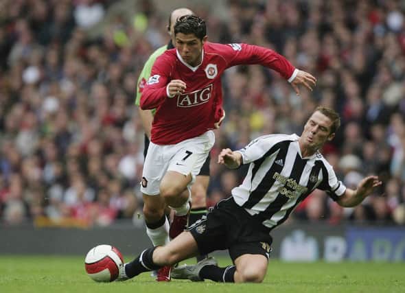 Scott Parker of Newcastle United tackles Cristiano Ronaldo of Manchester United during the Barclays Premiership match at Old Trafford on October 1, 2006. (Photo by Alex Livesey/Getty Images).