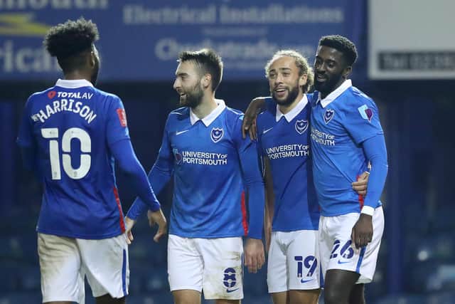 Portsmouth's Jordy Hiwula celebrates with teammate Ellis Harrison, Ben Close, and Marcus Harness after scoring a goal.