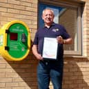 Rotary Washington Forge secretary Phil Hopps with a certificate of appreciation for the club's role in installing defibrillators in the town.