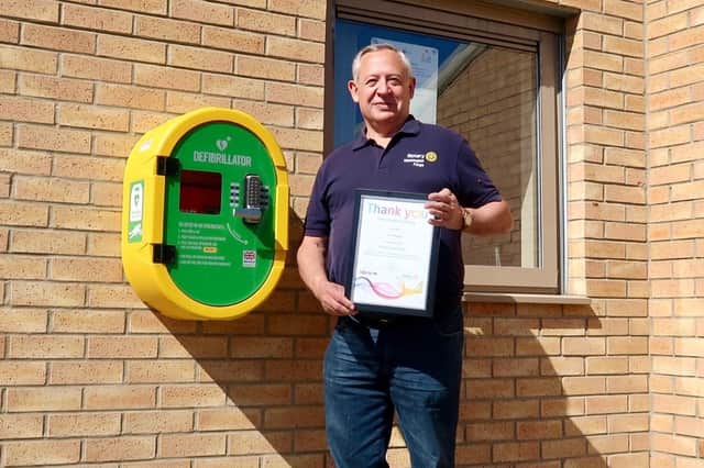 Rotary Washington Forge secretary Phil Hopps with a certificate of appreciation for the club's role in installing defibrillators in the town.
