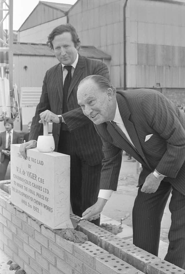 William De Vigier retiring chairman of Coles Cranes, lays the foundation stone of the new central store, watched by David Steel, managing director in April, 1982