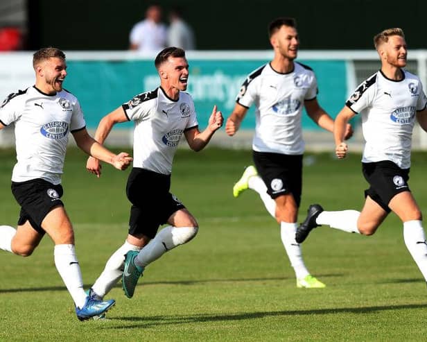 Gateshead players celebrate after their goalkeeper Bradley James save the last penalty in a penalty shootout to win the Vanarama National League North Play-Off match between Brackley Town and Gateshead.