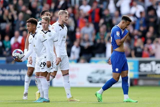 Players of Swansea City look on as Callum Robinson of Cardiff City leaves the field receiving a red card during the Championship between Swansea City and Cardiff City. (Photo by Ryan Hiscott/Getty Images)