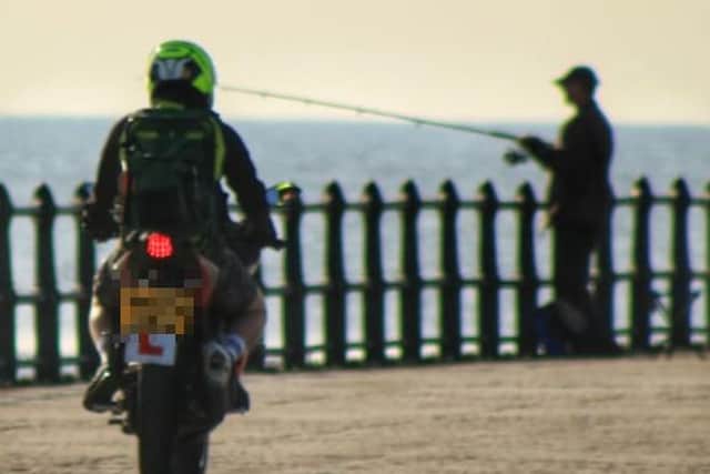 This photo captured the moment a biker rode on to Roker Pier.