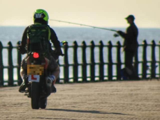 This photo captured the moment a biker rode on to Roker Pier.