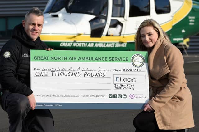 Jack Woodley's mother Zoey McGill presents a cheque for a £1000.00 pounds to GNAA paramedic Jamie Walsh.