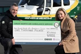 Jack Woodley's mother Zoey McGill presents a cheque for a £1000.00 pounds to GNAA paramedic Jamie Walsh.