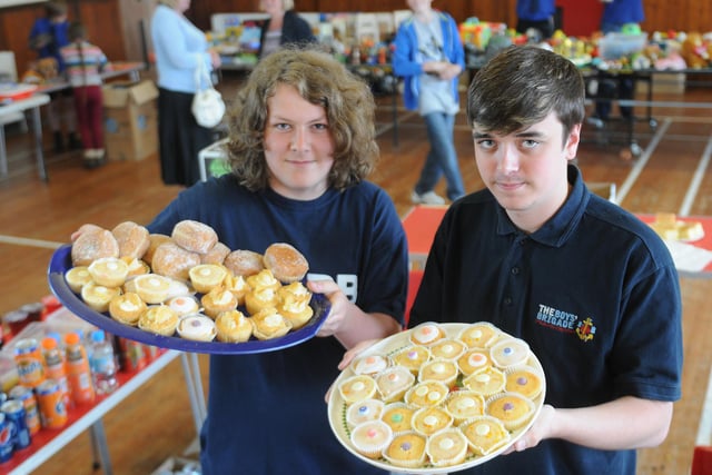 Boys Brigade members Stuart Matthews and Jack Hanlon (right) with cakes that were for sale during a fundraising event at St Matthews Hall eight years ago.