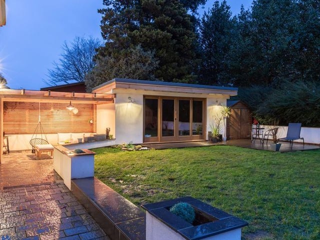 The back garden features a covered sunken terrace and a large, oak-framed room, described as ideal for an office or games room.