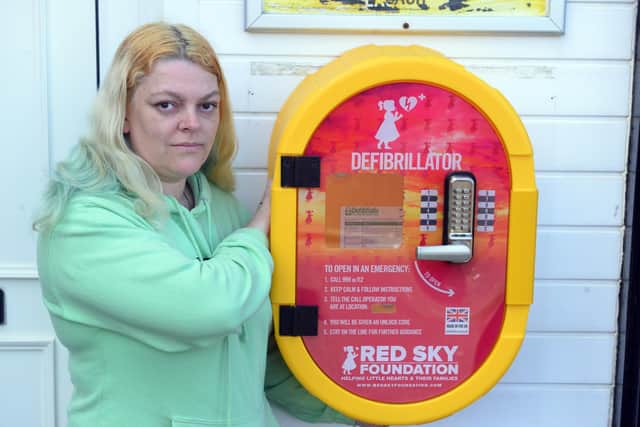 Cheryl Peacock with the defibrillator installed in memory of her mum Penny
