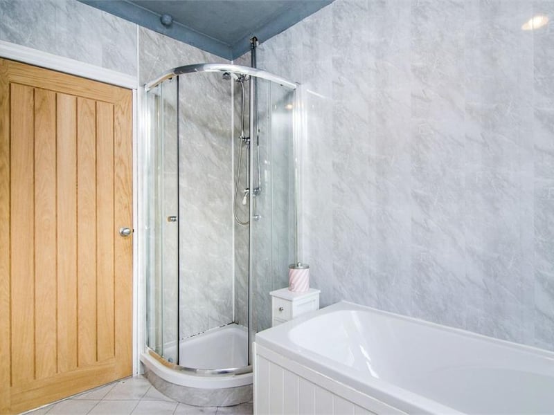 The family bathroom comprises of a bath, shower cubicle, toilet, hand basin and heated towel rail