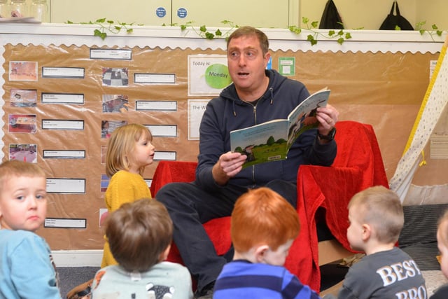 Reporter Neil Fatkin reading to the children at Stepping Stones Day Nursery.