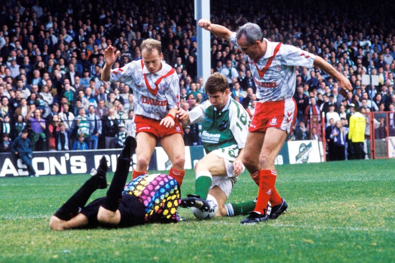Airdrie goalkeeper John Martin (left) dives at the feet of Jimmy Sandison, Keith Wright and Walter Kidd during a 2-2 draw in September 1992