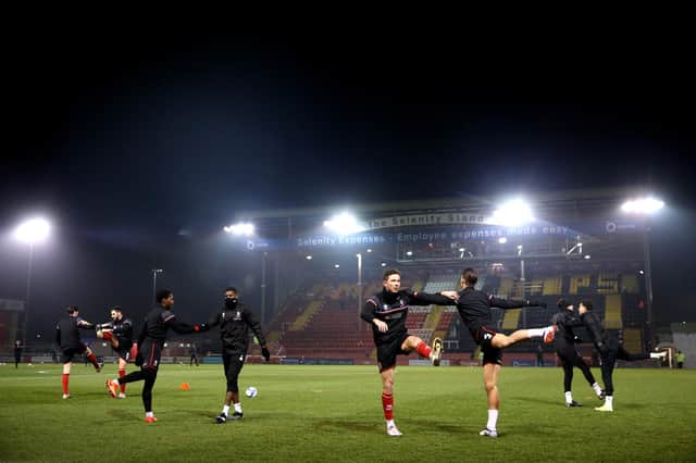LINCOLN, ENGLAND - MARCH 02: A general view as Lincoln players warm up prior to the Sky Bet League One match between Lincoln City and Fleetwood Town at Sincil Bank Stadium on March 02, 2021 in Lincoln, England. Sporting stadiums around the UK remain under strict restrictions due to the Coronavirus Pandemic as Government social distancing laws prohibit fans inside venues resulting in games being played behind closed doors. (Photo by Alex Pantling/Getty Images)