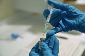 A needle is filled from a phial of Pfizer/BioNTech Covid-19 vaccine at the Royal Victoria Infirmary in Newcastle, on the first day of the largest immunisation programme in the UK's history.