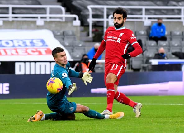 Newcastle United goalkeeper Karl Darlow saves a shot from Liverpool's Mohamed Salah.