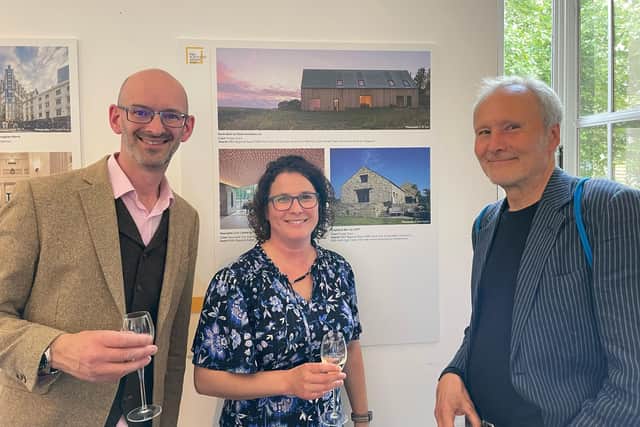 Mark Siddall, left, celebrates with Alison Church, structural engineer at Jackson-Church and Shepherd's Barn owner Paul Shepherd who lives there with his wife Sonny.