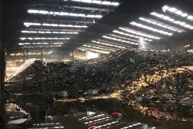 Mountains of waste piled up against the shed during the fire at the site in May 2018.