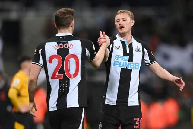 Sean Longstaff and Chris Wood celebrate Newcastle United's victory over Wolves (Photo by Stu Forster/Getty Images)