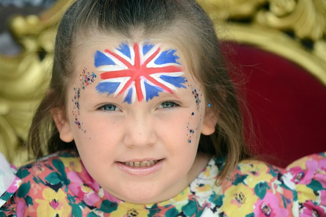 Ravarna May, 6, shows off her face paint and glitter.