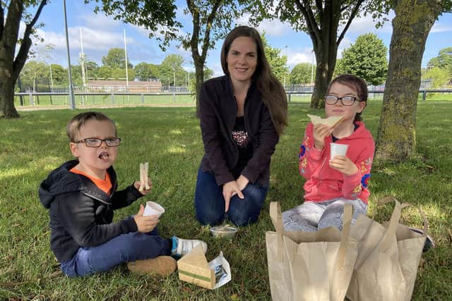 Rebecca Dawson, 35, with her children James, 4, and Lucy, 8, having their free nutritious lunch provided by the Summer Bus at Houghton Kepier Academy.
 
Picture by Frank Reid
