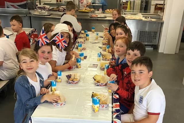 Children from Burnside Academy enjoying their Royal picnic lunch.
