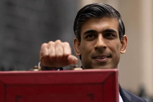 Chancellor Rishi Sunak holds the budget box as he departs to deliver the Budget today