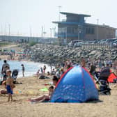 Crowds on Roker Harbour Beach during the warm weather in July.