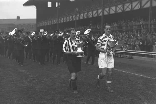 Captains of Sunderland and Celtic, Raich Carter and Willie Lyon, show off the English and Scottish FA Cups before a friendly at Roker Park in October 1937.