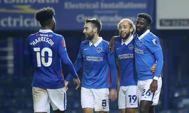 Jordy Hiwula-Mayifuila of Portsmouth celebrates with teammate Ellis Harrison, Ben Close, and Marcus Harness after scoring his team's sixth goal  during the FA Cup Second Round match between Portsmouth FC and King's Lynn Town on November 28, 2020 in Portsmouth, England. (Photo by Naomi Baker/Getty Images)