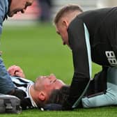 Newcastle United defender Fabian Schar receives medical treatment at Wembley.