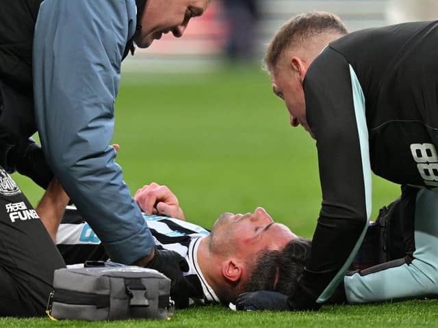 Newcastle United defender Fabian Schar receives medical treatment at Wembley.