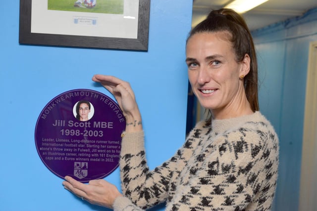 Jill poses with her plaque.