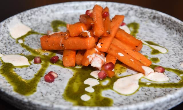 Roasted carrots with chilli, garlic and honey dressed in carrot top pesto and spiced yoghurt