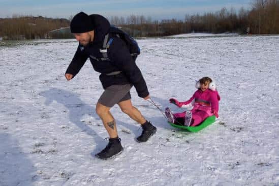 Michael Ward and his daughter Sasha enjoy the snow after their clear up mission.