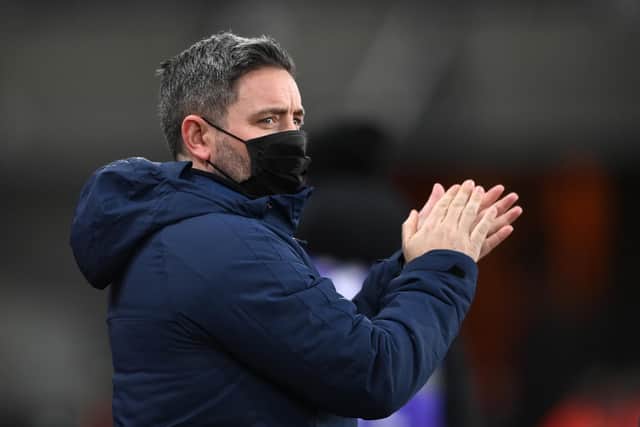 SUNDERLAND, ENGLAND - JANUARY 11: Sunderland manager Lee Johnson applauds the fans wearing a face mask during the Sky Bet League One match between Sunderland and Lincoln City at Stadium of Light on January 11, 2022 in Sunderland, England. (Photo by Stu Forster/Getty Images)