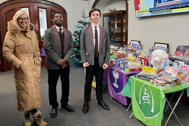 Anneline Dowell of Hope 4 Kidz with pupils from Christ's College and their donations.