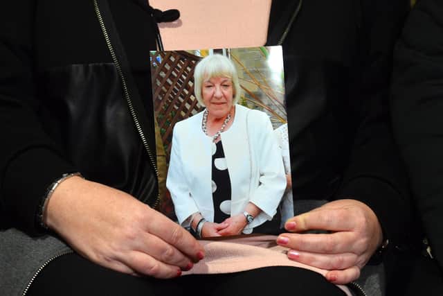 Michelle Young holds a picture of her mum Joan Hoggett