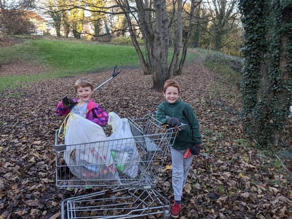 Andrew Saville and his brother Matthew rescuing a shopping trolley.