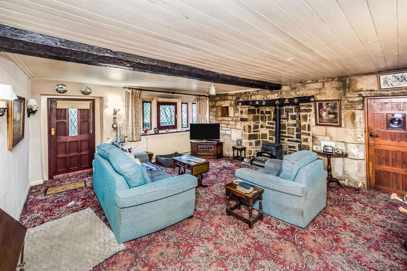 With feature fireplace, beamed ceiling and traditional log burner.