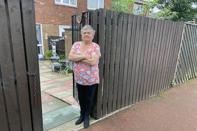 Verna Cole at the back gate of her Sunderland home where her wheelie bin was stolen from. Picture by FRANK REID