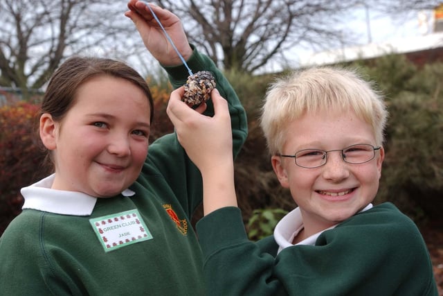 Jade Turnbull and Luke Hobson had fun showing off the bird feeder which they made at the Broadway Junior School Wildlife and Gardening Club in 2003.