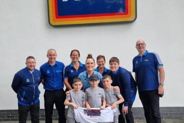 Oliver and his brothers with the Aldi skydive team, including aunt Aylsa Wilson, front centre
