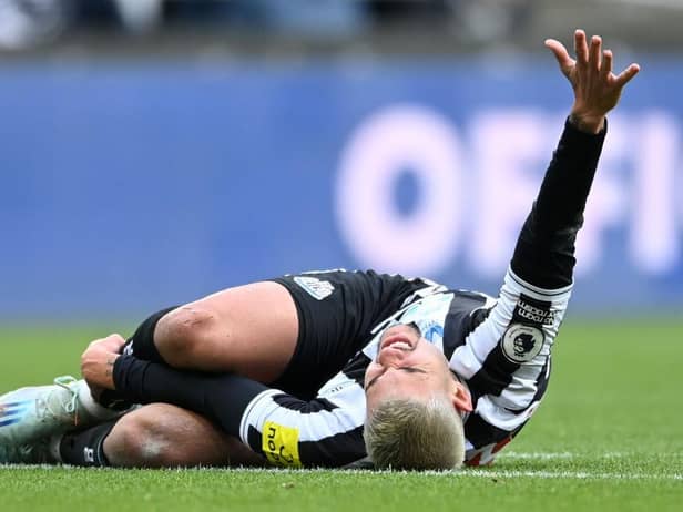 Bruno Guimaraes of Newcastle United goes down with an injury during the Premier League match between Newcastle United and Fulham FC at St. James Park on January 15, 2023 in Newcastle upon Tyne, England. (Photo by Michael Regan/Getty Images)