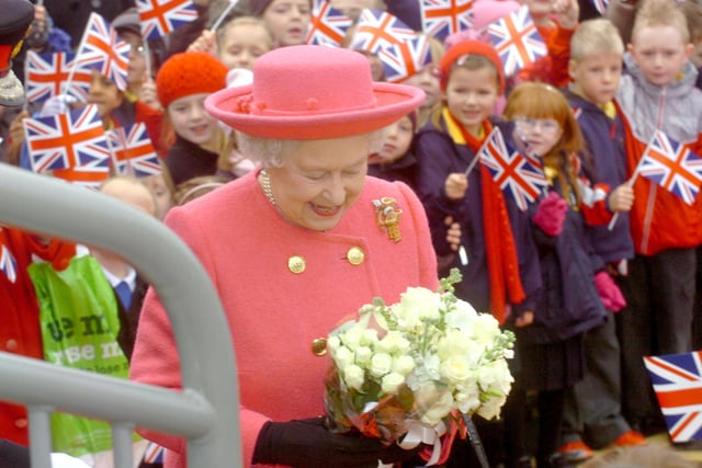 Her Majesty arrives at the Stadium of Light Metro station to scores of children waving flags in 2009.