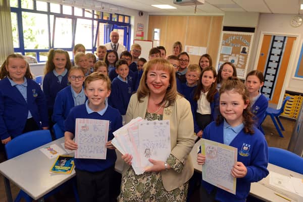 MP Sharon Hodgson with children from Castletown Primary School holding some of the letters they had wrote.